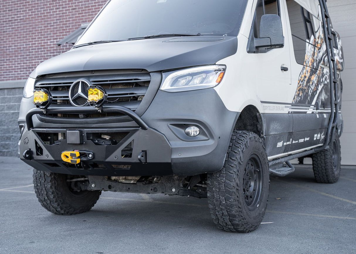 Driver-side profile of a Mercedes-Benz Sprinter van featuring the ROAMBUILT LoPro Front Bumper, highlighting its lightweight aluminum shell, integrated bull bar, and seamless fit that adds only 3 inches of bulk, aligning perfectly with the vehicle's body lines.