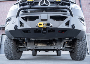 Close-up of the lower section of a Mercedes-Benz Sprinter's ROAMBUILT LoPro Front Bumper, highlighting the integrated steel 2-inch receiver hitch and 1-inch thick shackle mounts, all encased within a lightweight 5052 aluminum outer shell.