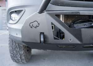 Front view of a Mercedes-Benz Sprinter van featuring the ROAMBUILT LoPro Front Bumper, highlighting integrated 1-inch thick steel shackle mounts and precision-machined sensor housings designed to accommodate factory parking sensors within the lightweight aluminum shell.