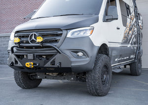 Driver-side profile of a Mercedes-Benz Sprinter van featuring the ROAMBUILT LoPro Front Bumper, highlighting its lightweight aluminum shell, integrated bull bar, and seamless fit that adds only 3 inches of bulk, aligning perfectly with the vehicle's body lines.