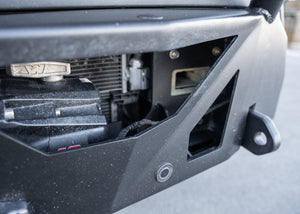 Close-up of the ROAMBUILT LoPro Front Bumper on a Mercedes-Benz Sprinter van, featuring a Warn VR-EVO winch with hawse fairlead, integrated parking sensors, and 1-inch thick steel shackle mounts, all encased within a lightweight 5052 aluminum outer shell.