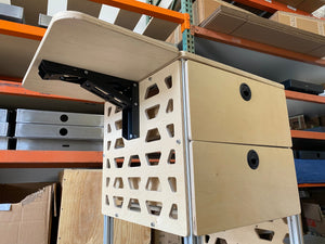 tetravan moab bracket attached to cabinet in campervan with drop down table and drawer system ventilated campervan cabinet
